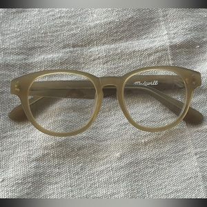 Madewell used tan/caramel non-prescription clear lens glasses. Not blue lenses.